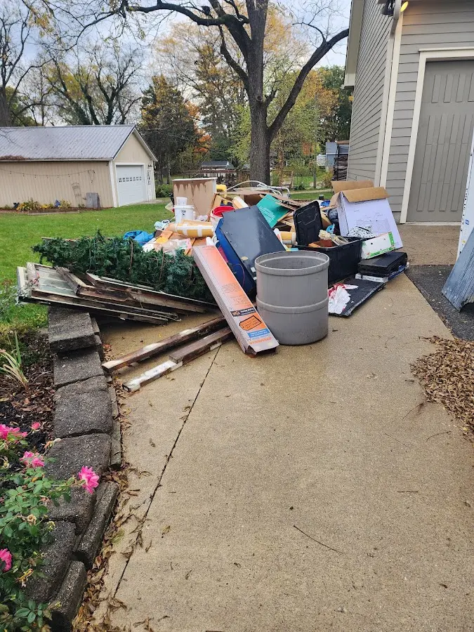 Dumpster being loaded with debris for Roofing Dumpster Rental in Meadow Woods